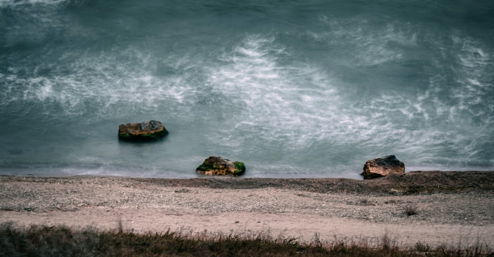 brown rock formation on sea shore during daytime