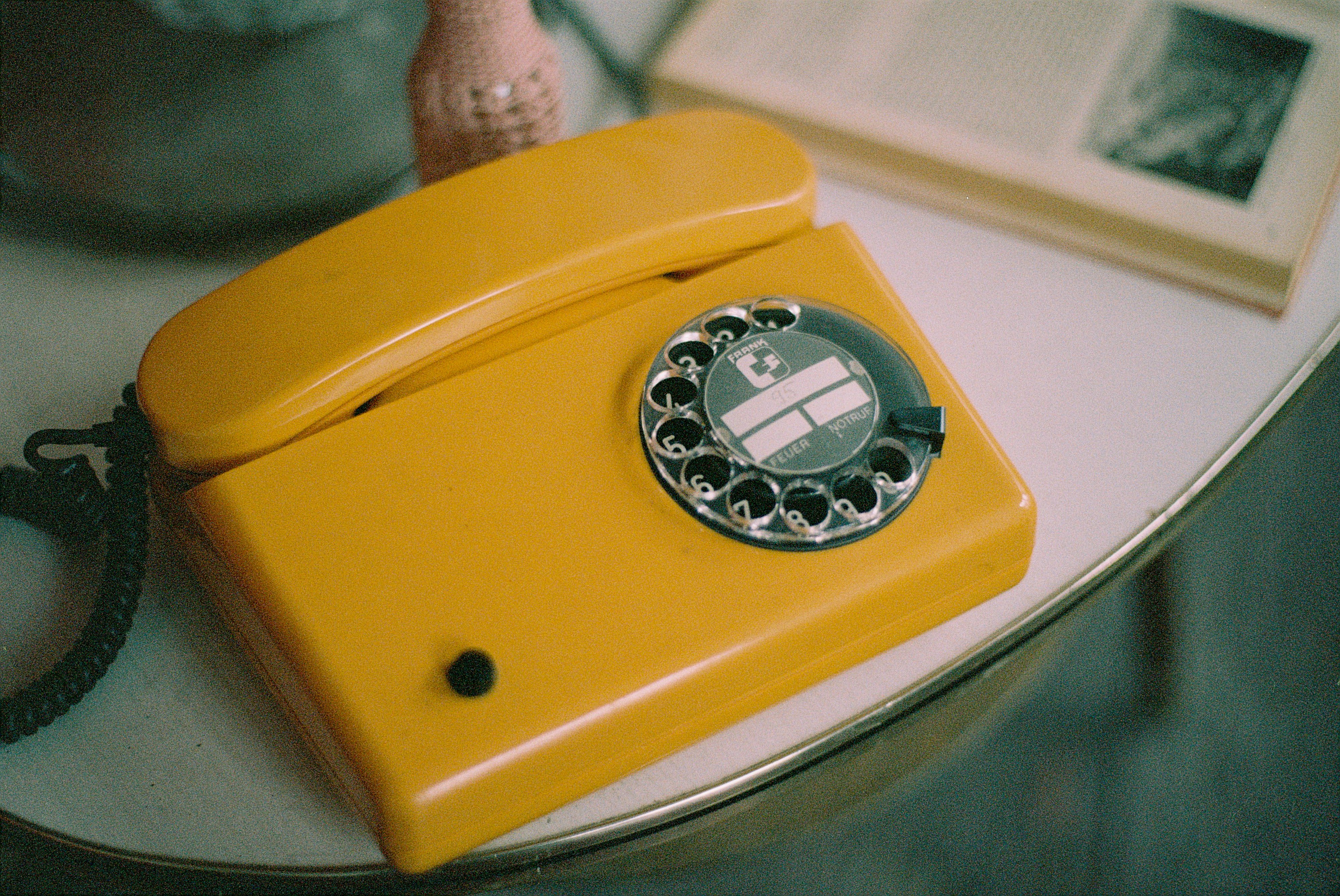 yellow and silver rotary phone