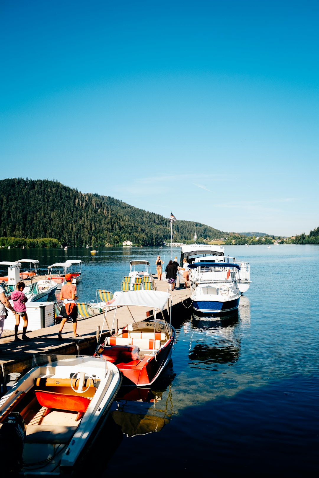 people riding on boat on lake during daytime