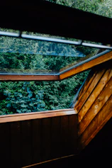 Bright and airy garden loft interior with natural wood accents and leafy views.