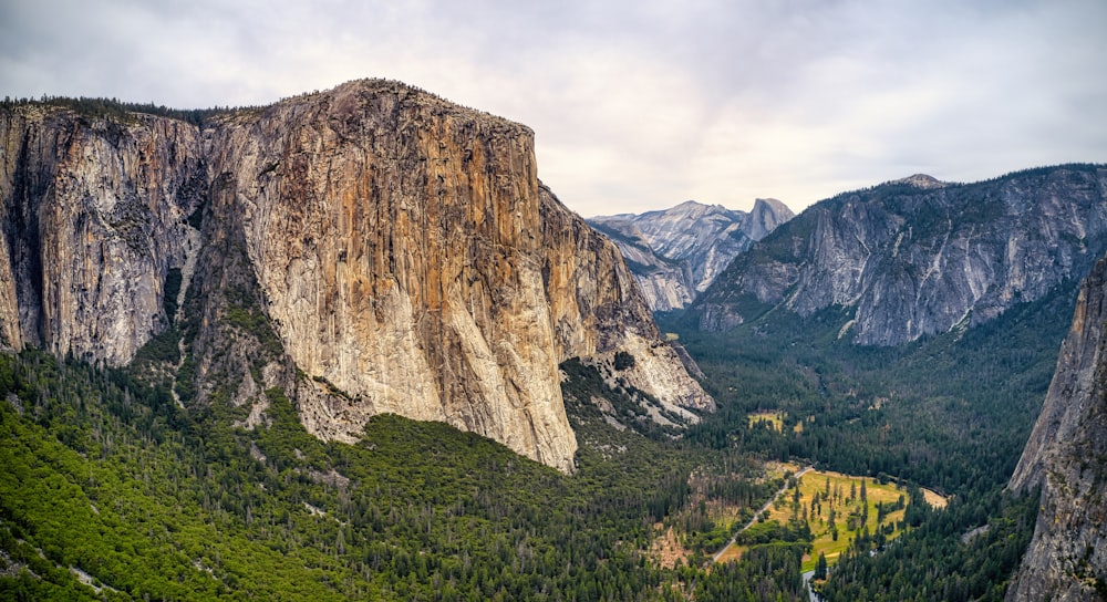 green grass and brown rocky mountain during daytime