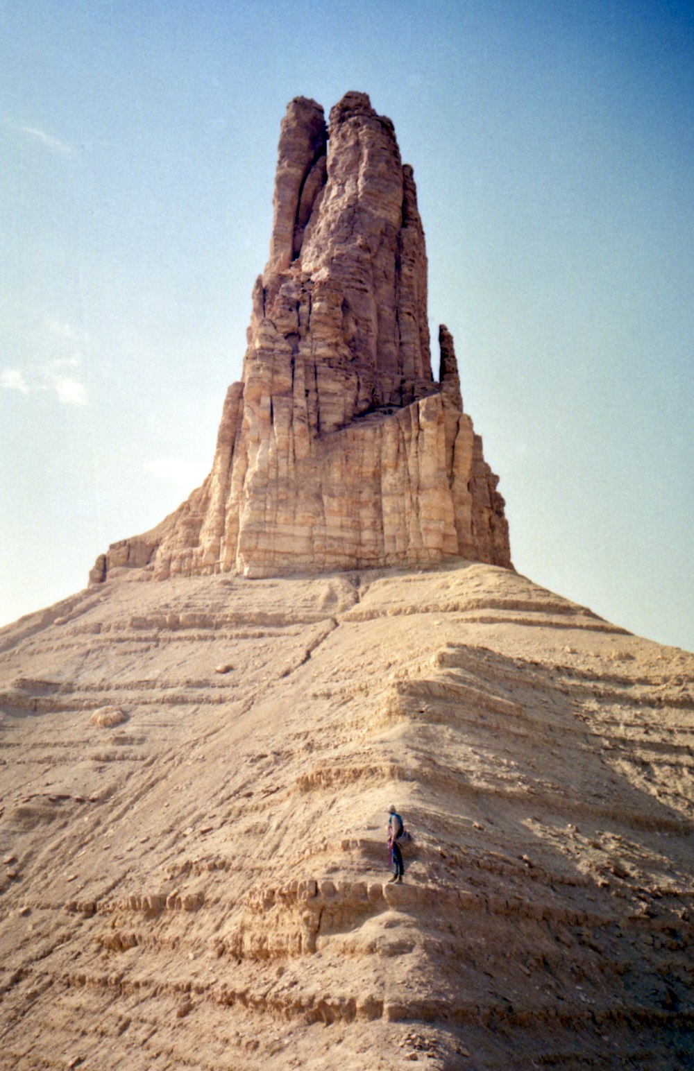 person standing on brown rock formation during daytime