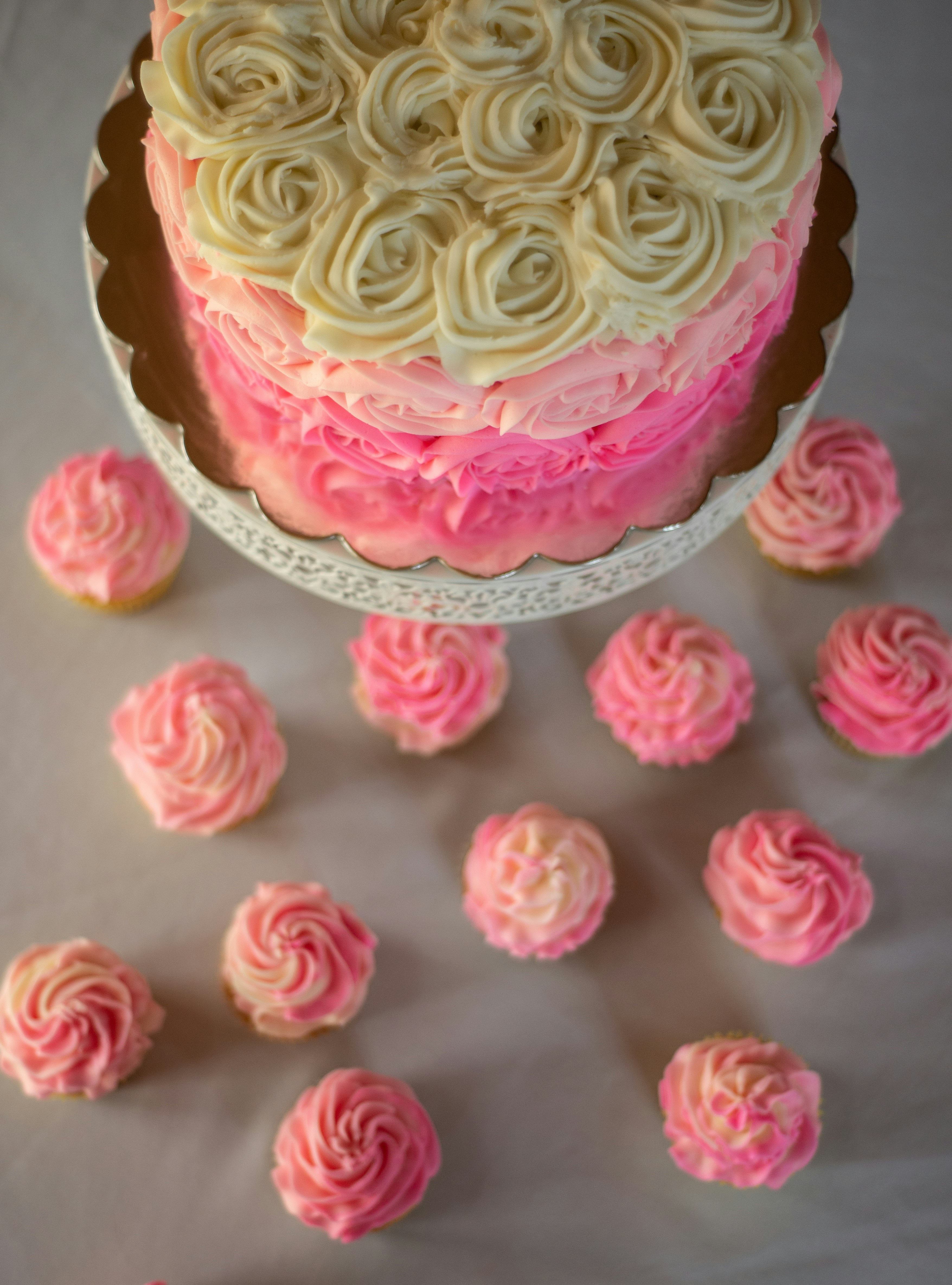 pink and yellow cupcake with pink icing on top