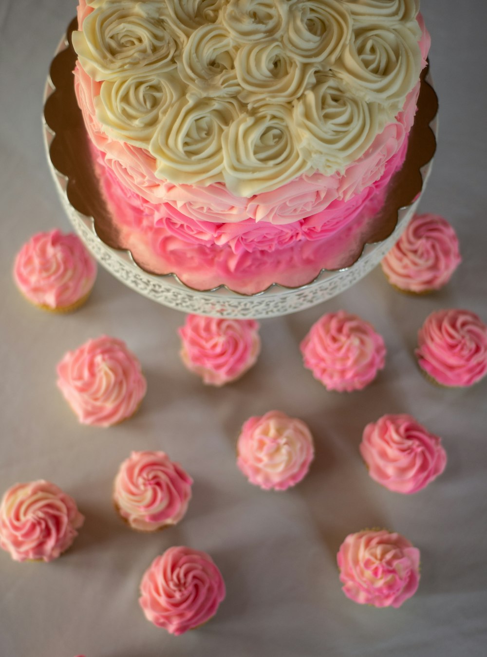 pink and yellow cupcake with pink icing on top