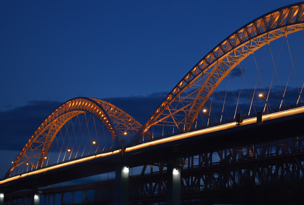 gray metal bridge under blue sky during daytime