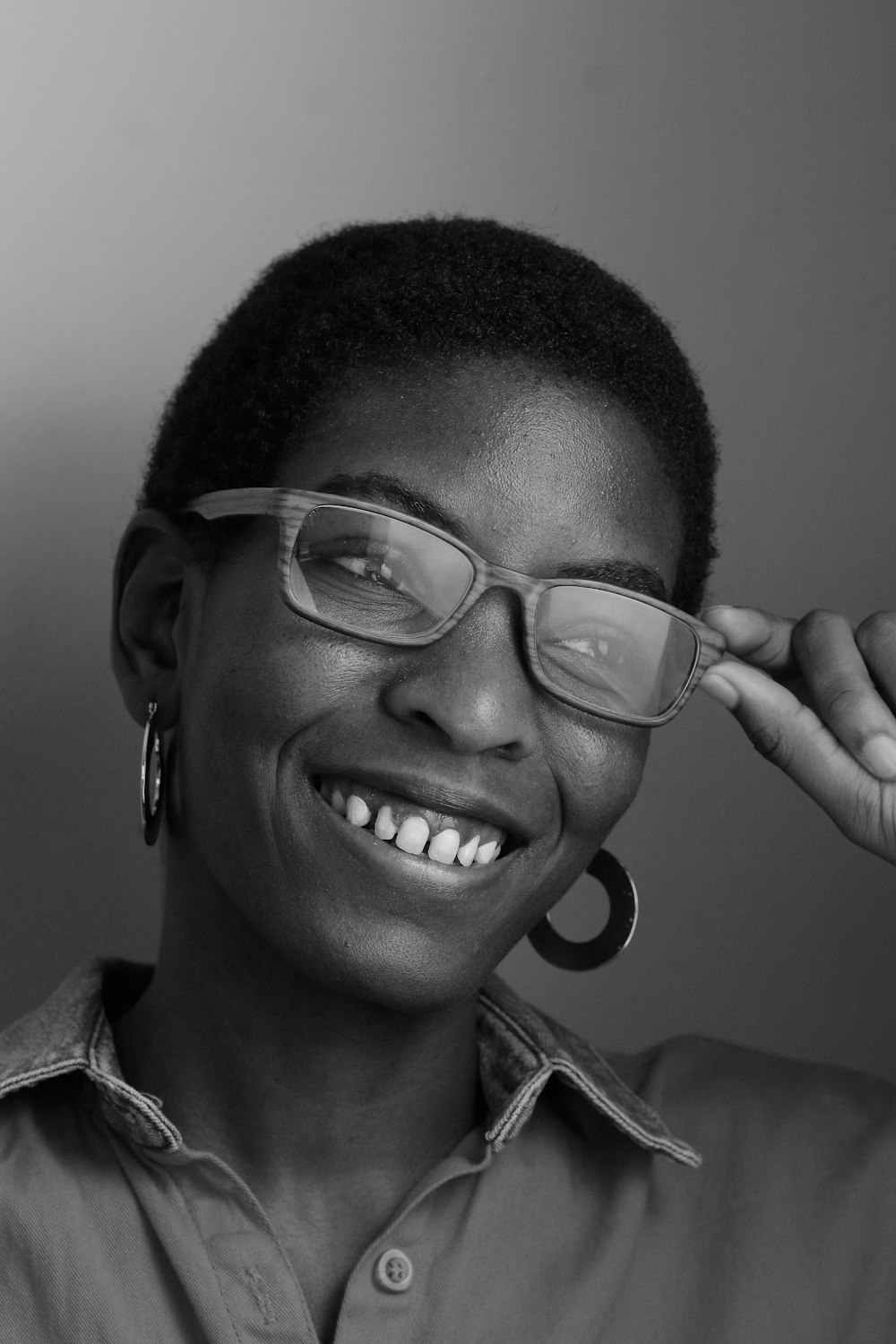 grayscale photo of smiling boy wearing eyeglasses