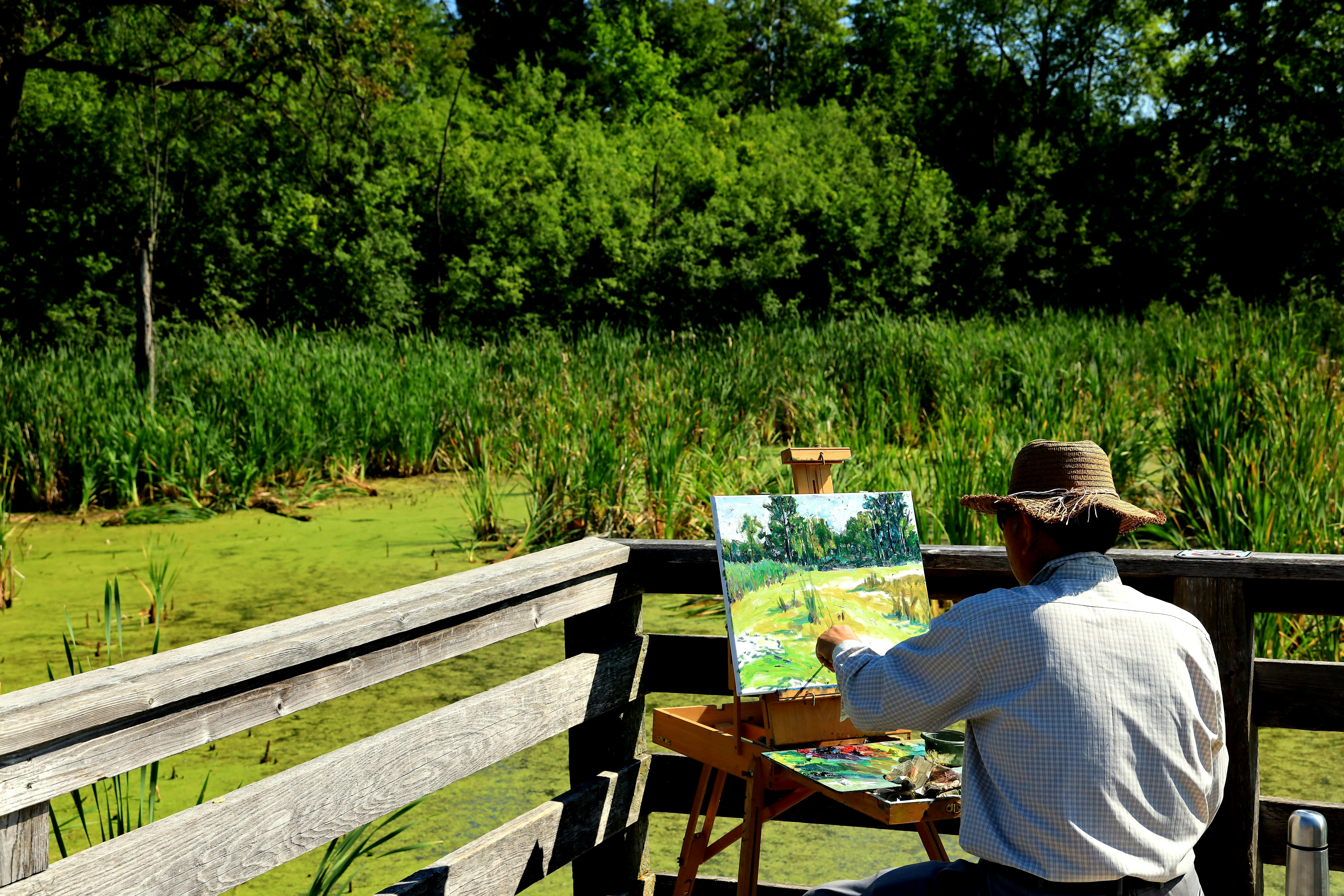 man in white shirt sitting on brown wooden bench