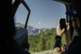 A vibrant photo of a travel influencer capturing a scenic mountain view.