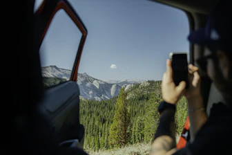 A vibrant photo of a travel influencer capturing a scenic mountain view.