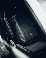 An organized car interior showcasing stylish seat covers and a travel sport sling bag.