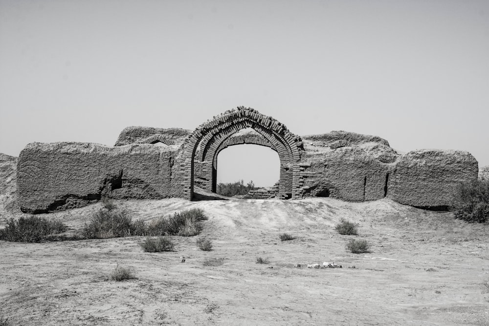 brown concrete arch on brown field during daytime