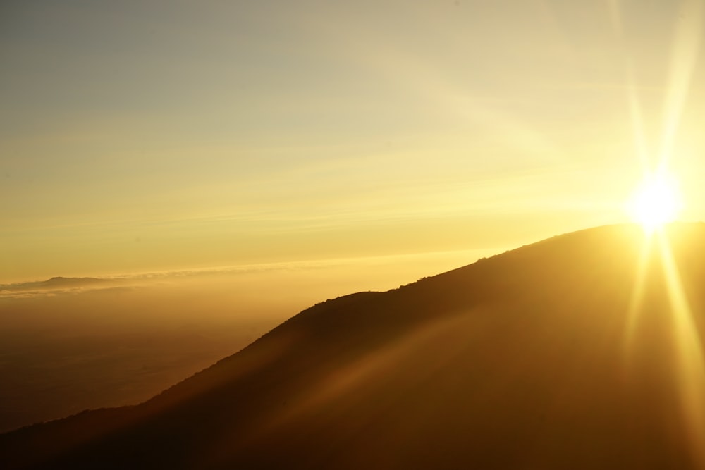 silhouette of mountain during sunset