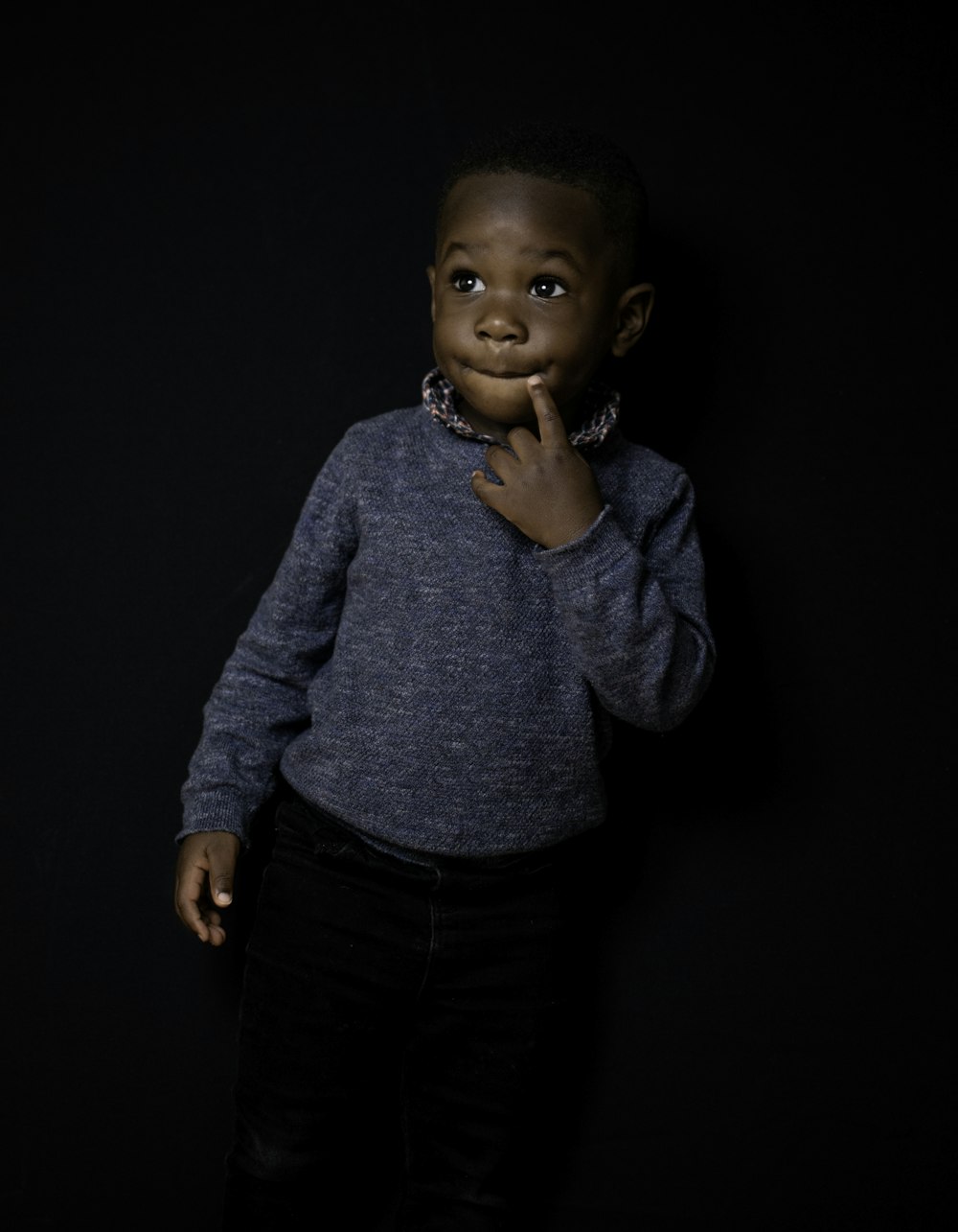 boy in gray sweater and black pants