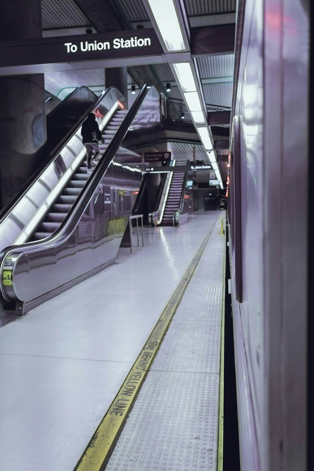 black escalator on white floor tiles