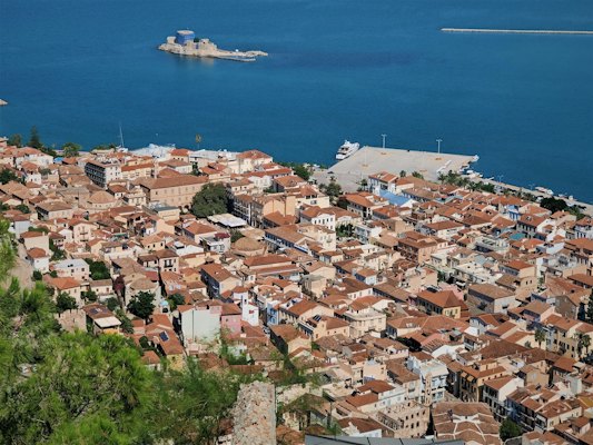 Aerial view of city buildings near body of water during daytime — Nafplio, Greece