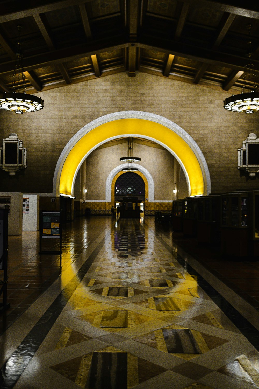 people walking on hallway with lights turned on during night time