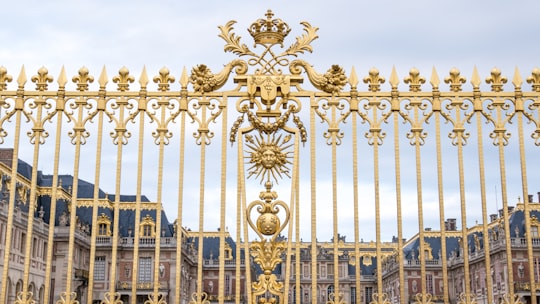 gold and blue metal gate in Palace of Versailles France