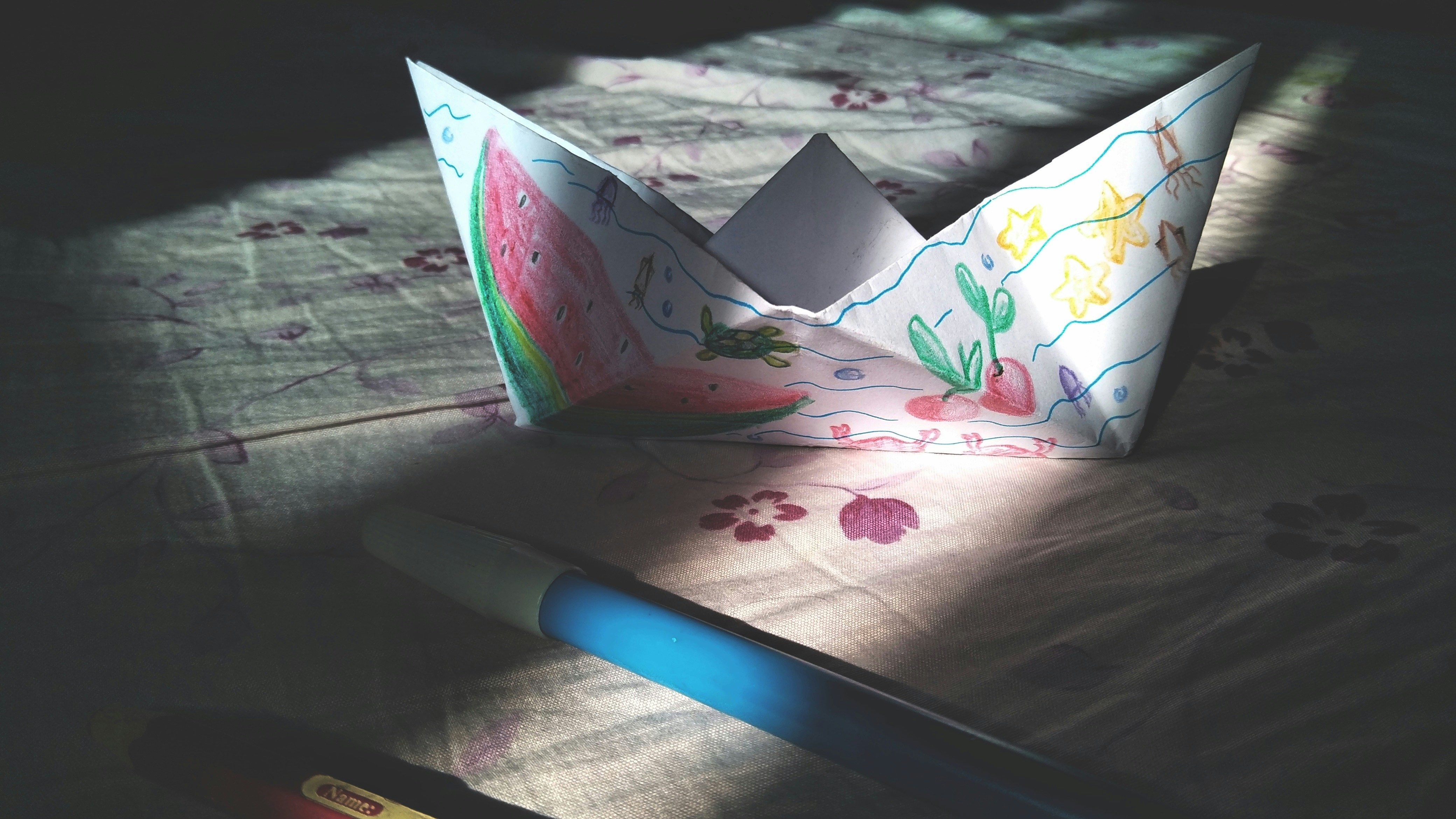 white paper on pink floral print textile