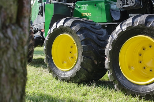 green tractor on green grass field during daytime