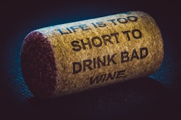 a cork with a message on it that says, life is too short to drink