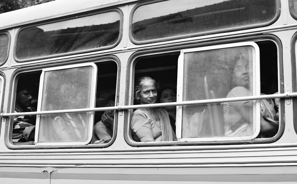 grayscale photo of woman in train