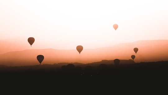 hot air balloons in the sky during sunset in Kapadokya Turkey