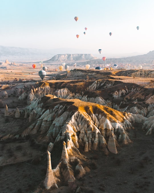 people on top of mountain during daytime in Kapadokya Turkey