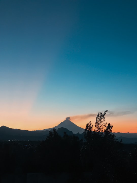 silhouette of trees and mountains during sunset in Popocatepetl Mexico