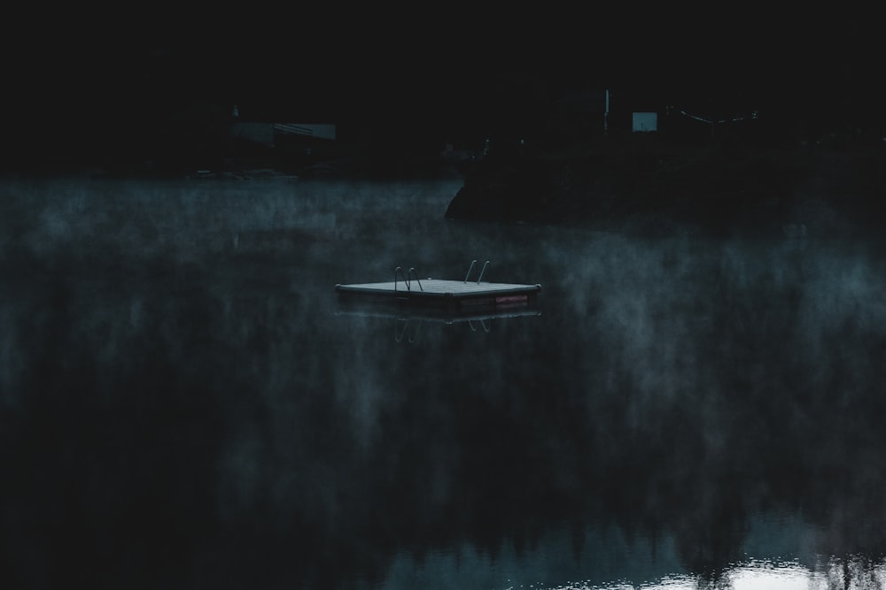 white boat on body of water during night time