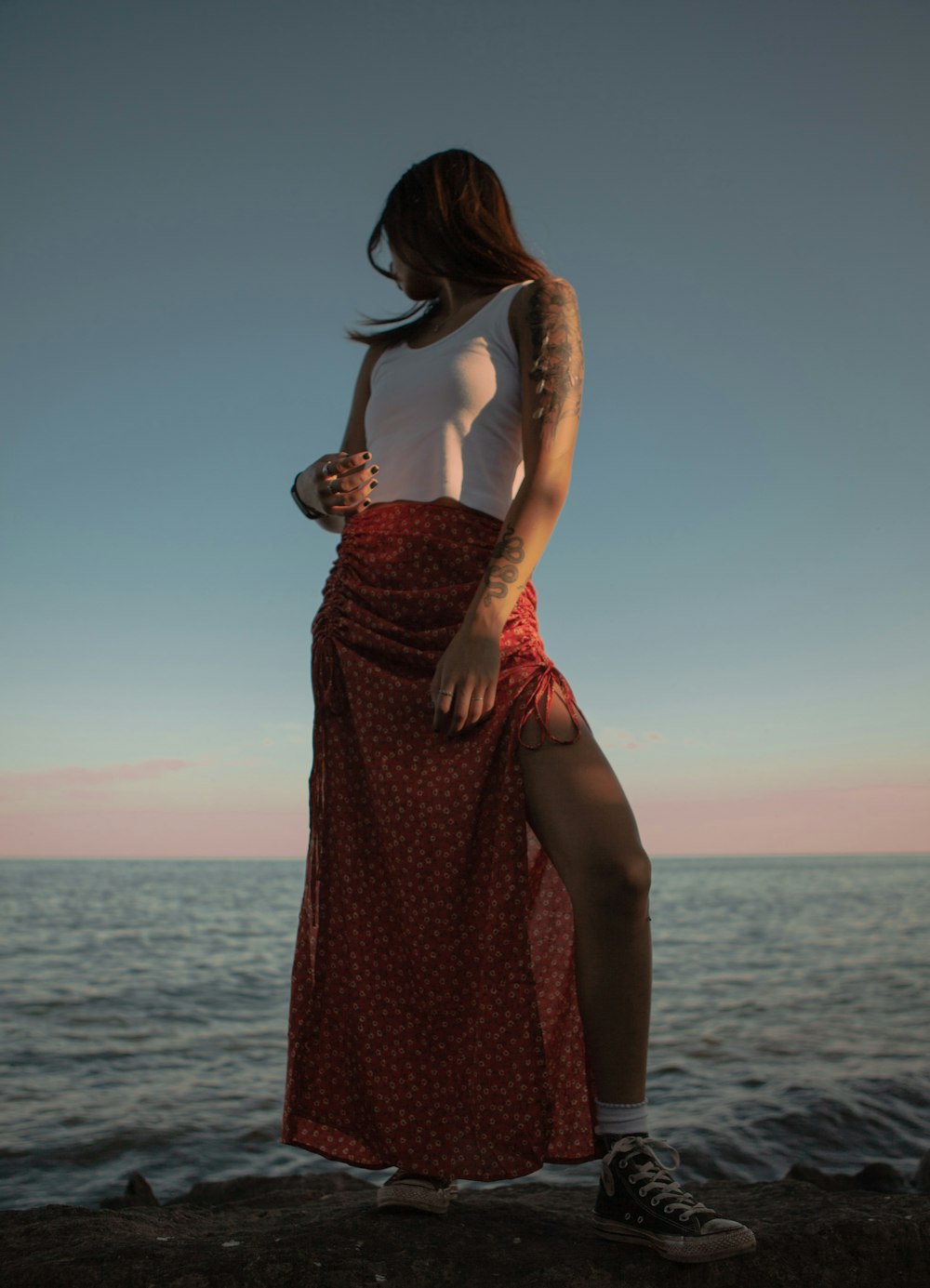 woman in brown sleeveless dress standing on beach during daytime