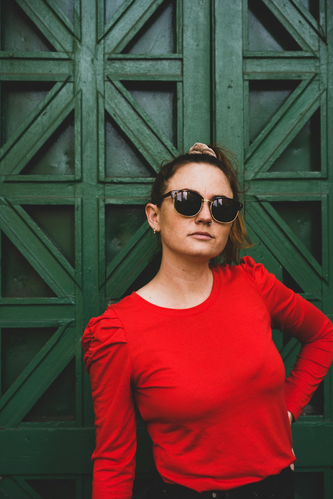 woman in red long sleeve shirt wearing black sunglasses