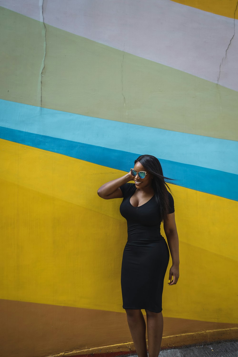 woman in black tank top and black pants wearing sunglasses