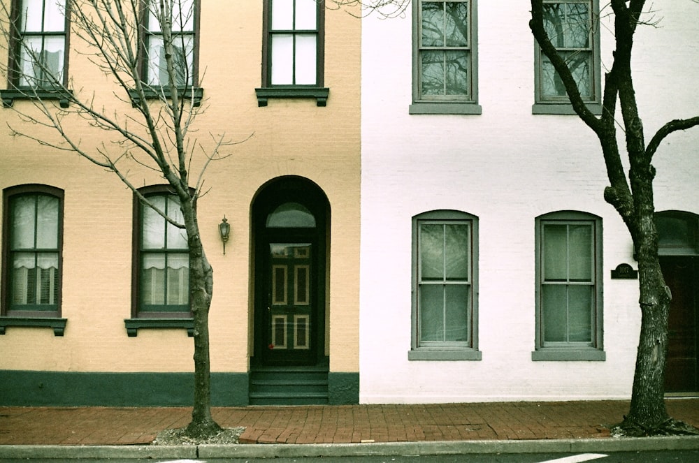 white concrete building with black wooden window