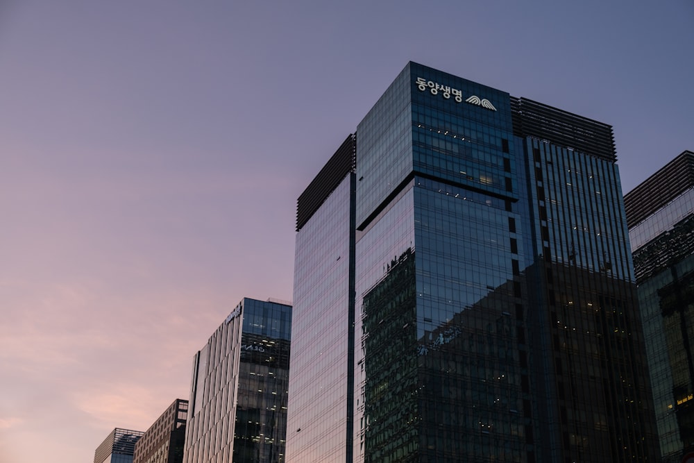 blue and white glass walled high rise building