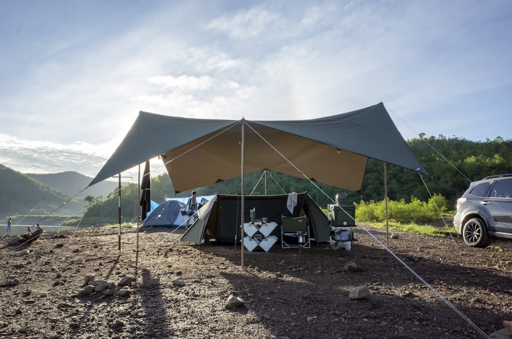 blue and white tent on brown ground during daytime