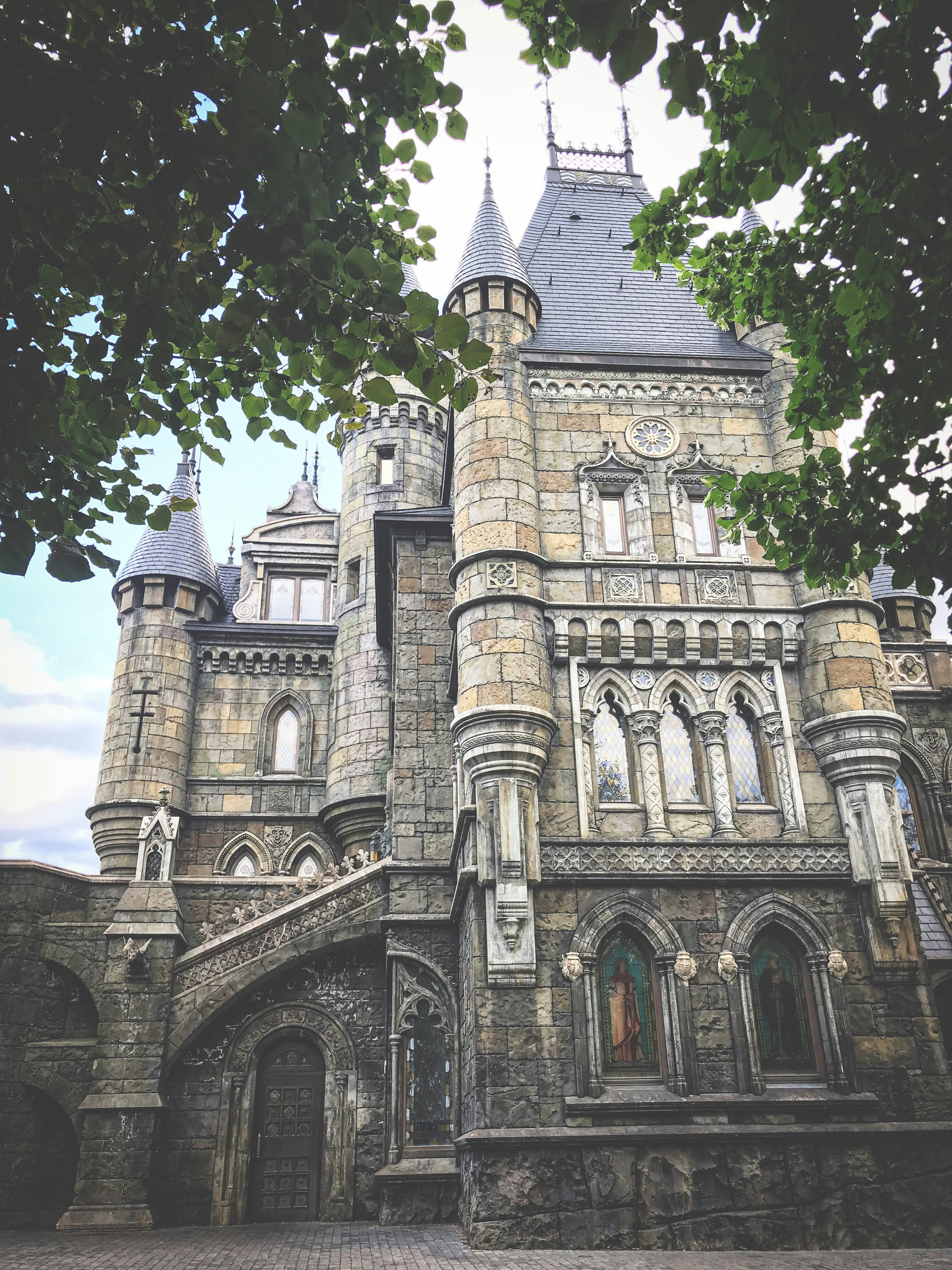 grey concrete building near green trees during daytime