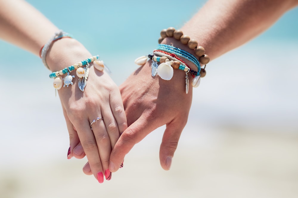 person wearing blue and white beaded bracelets