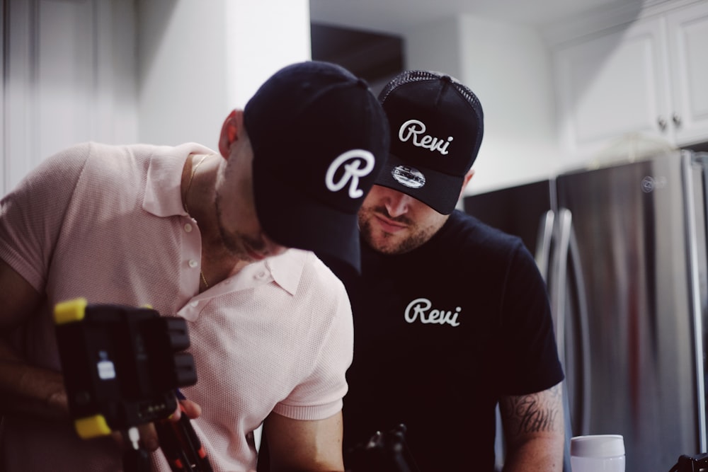 man in black and white crew neck t-shirt wearing black cap