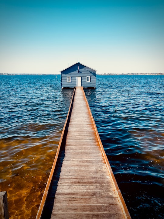 brown wooden dock on sea during daytime in Blue Boat House Australia