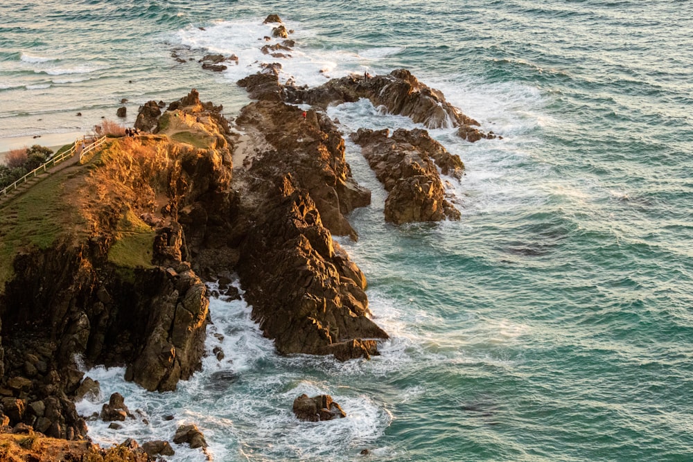 brown rock formation on sea during daytime