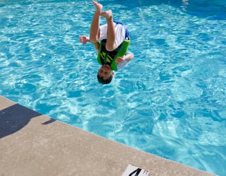 2 boys in swimming pool during daytime