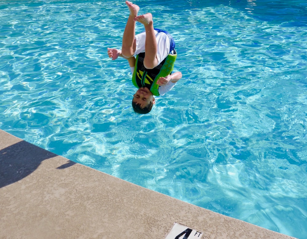 2 boys in swimming pool during daytime