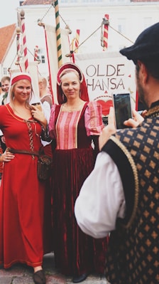 woman in red dress standing beside woman in white dress