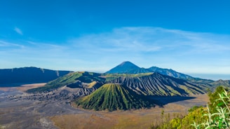 A vibrant aerial view of Tenerife's volcanic landscape under a bright blue sky