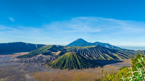 A vibrant aerial view of Tenerife's volcanic landscape under a bright blue sky