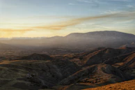 A sweeping landscape of nature with soft cinematic lighting at sunset.
