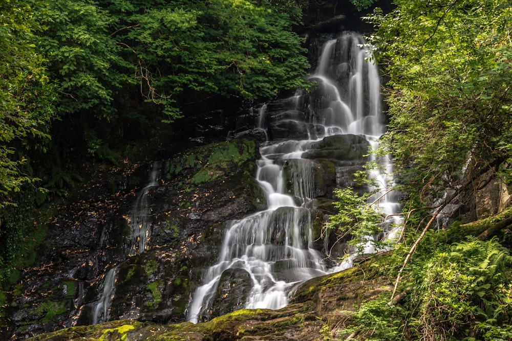 waterfalls in the middle of the forest