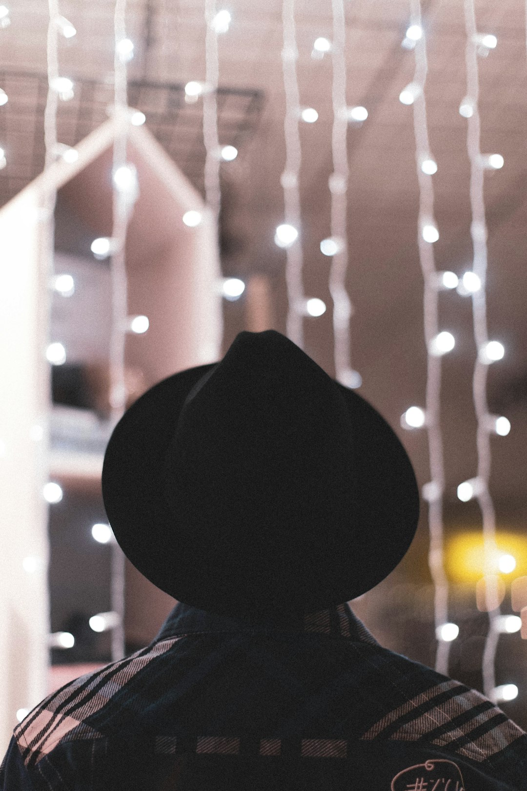 bokeh photography of person wearing black hat