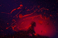 Artistic video still featuring a silhouette against a dark, textured background