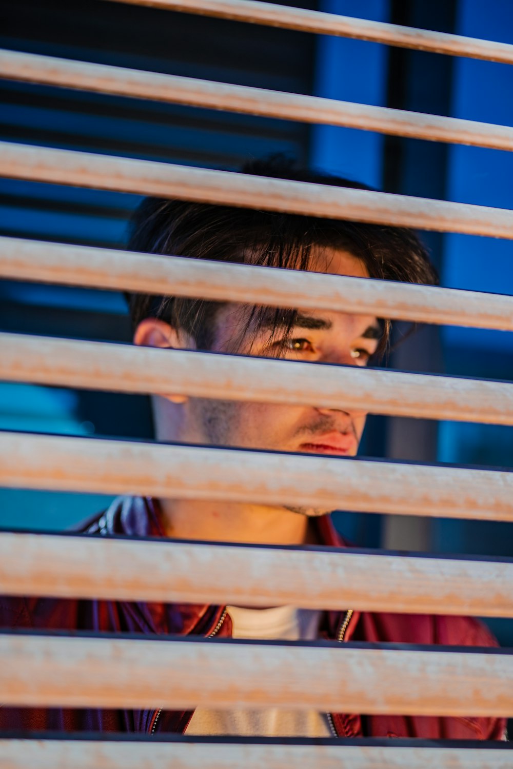 woman in black shirt leaning on blue metal fence